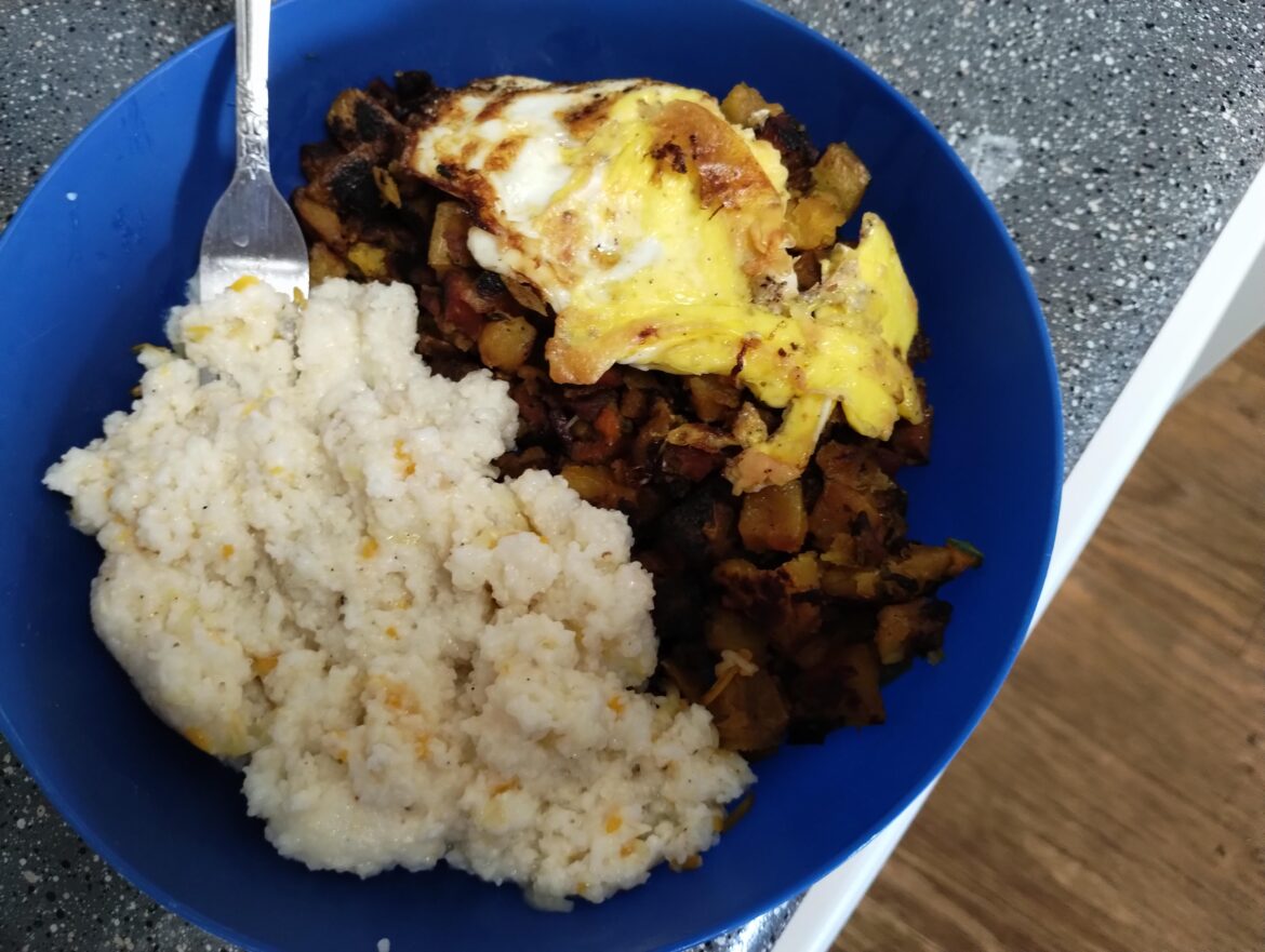 Homemade Hash with cheesey grits and a fried egg ontop
