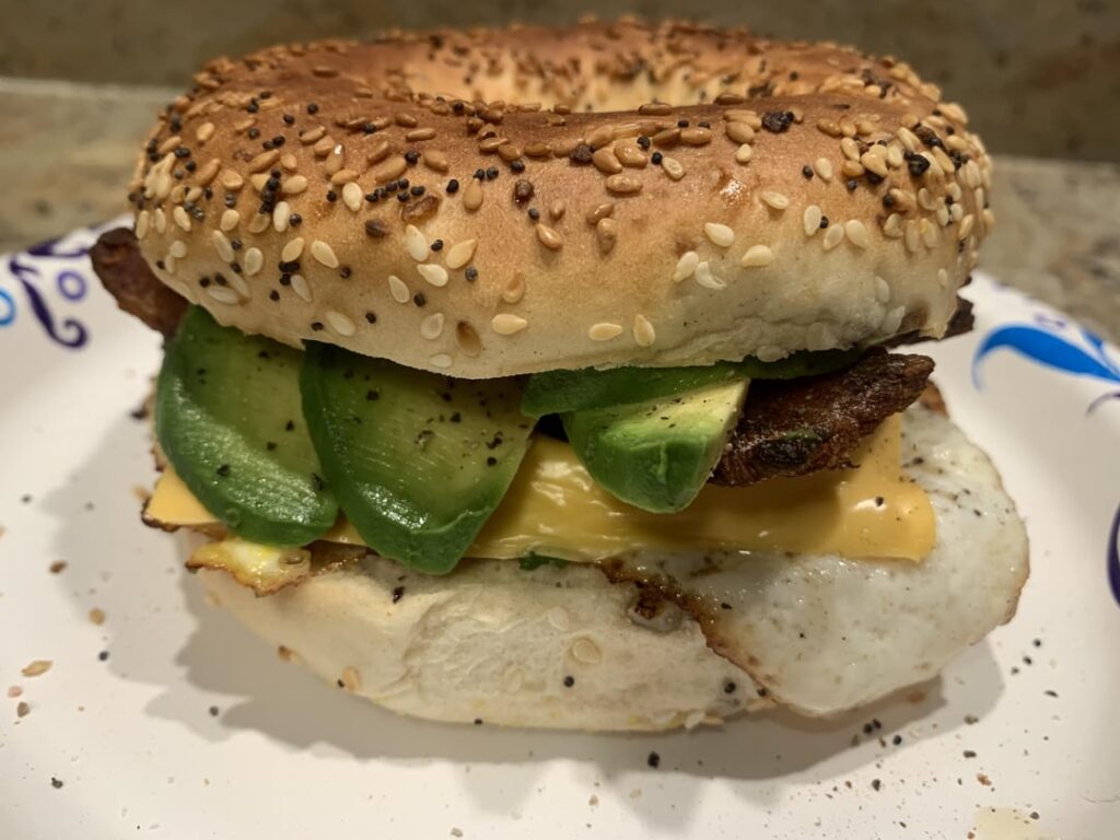 Egg, bacon, cheese and avocado on an everything bagel