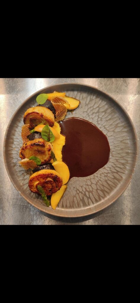 Pork belly with beer and brown sugar apples and black pudding.