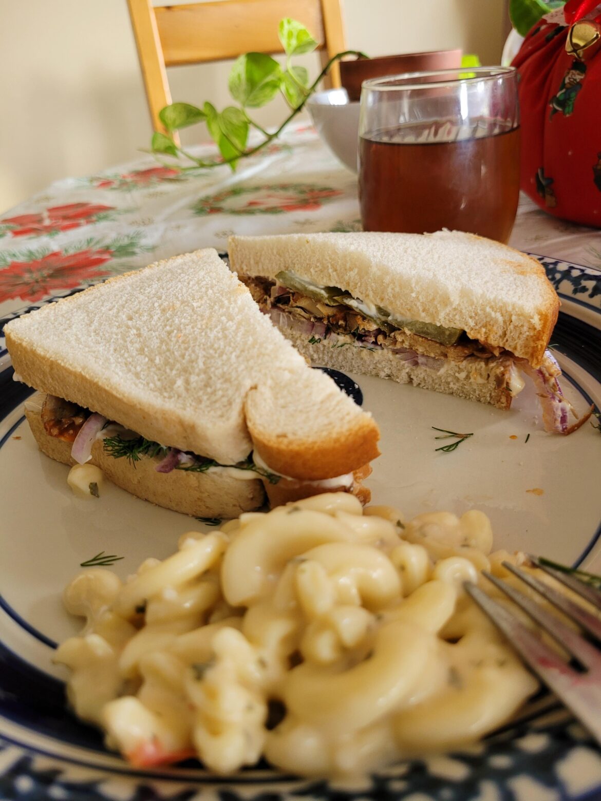 Sandwich with sardines in tomato sauce, onion, dill, and a pickle