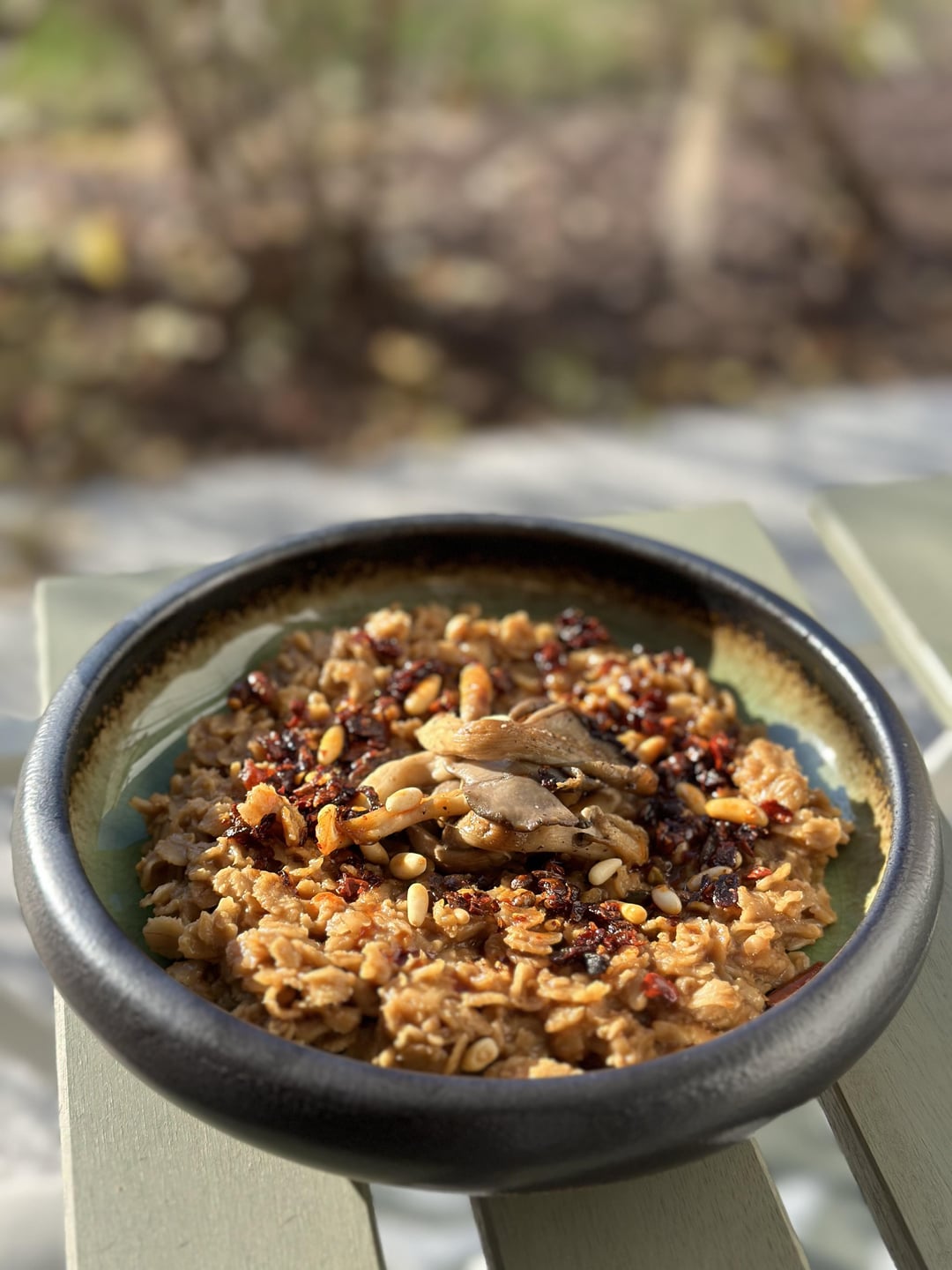 Savory oats in “not chicken” broth topped with chili oil, seared oyster