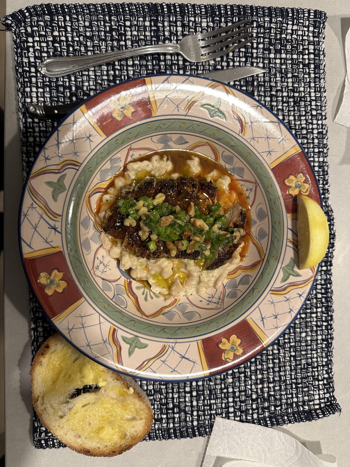 Pork chops over white beans with walnut gremolata and pan sauce