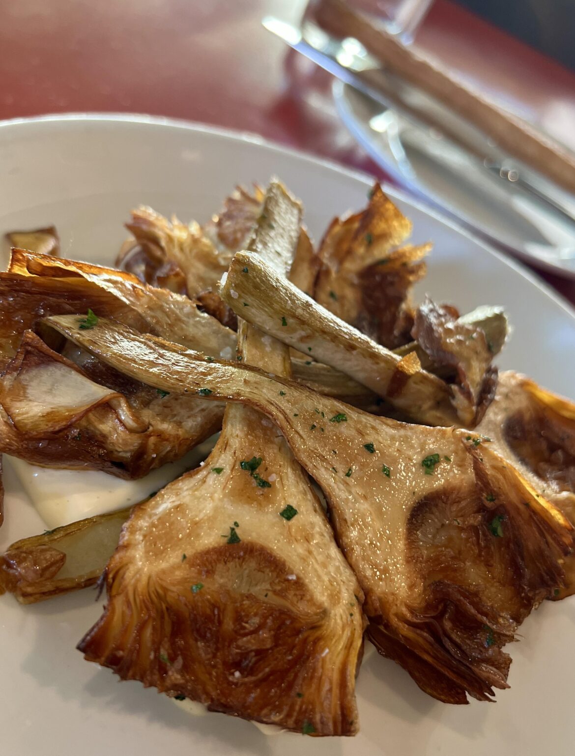 Fried artichokes at Asti while I wait for the John Waters Christmas show