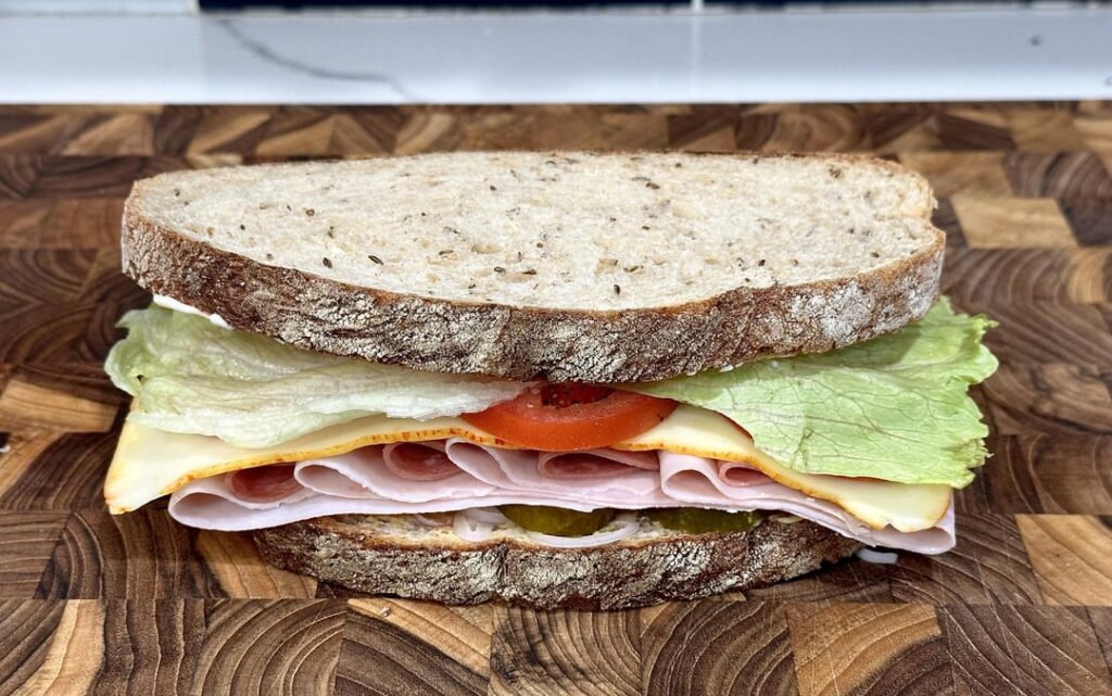 polish ham, salami and muenster on rye w/ shallot, pickle, lettuce, tomato, mayo and dijon.