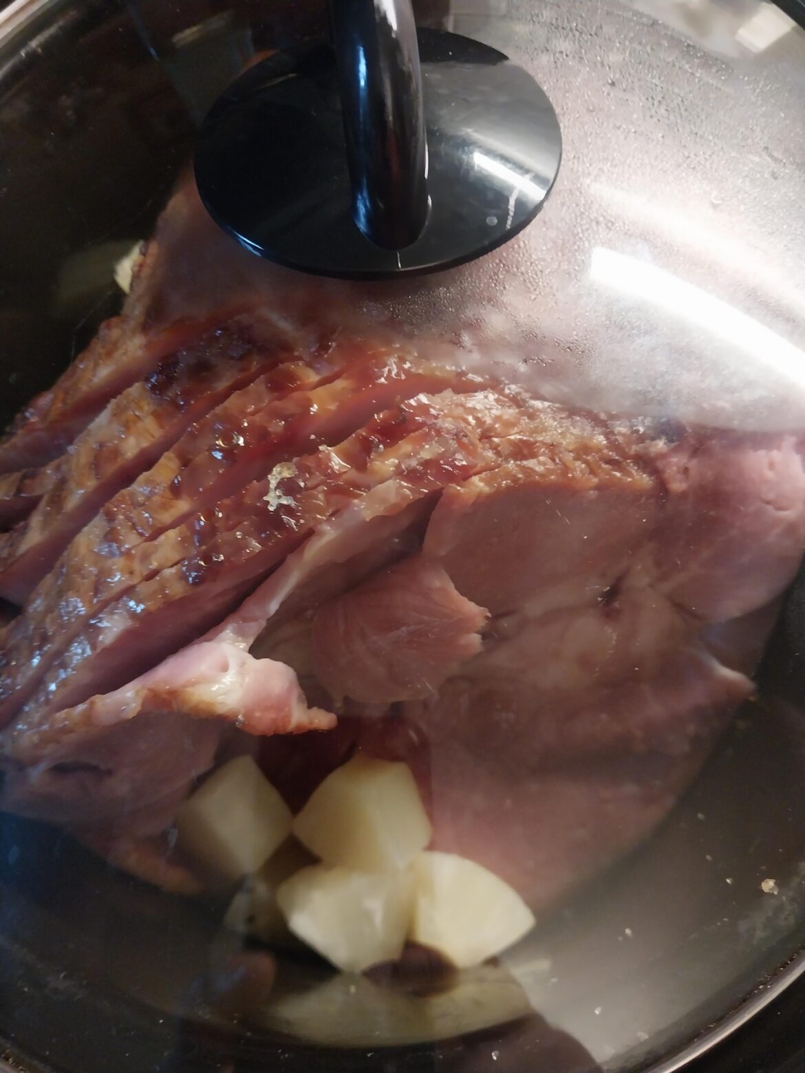 Christmas Ham in the slow cooker. Rubbed it with some garlic powder and brown sugar. Poured a can of chunk pineapple in and squeezed the glaze over it all. Love being able to get a $9 ham at Meijer in MI.