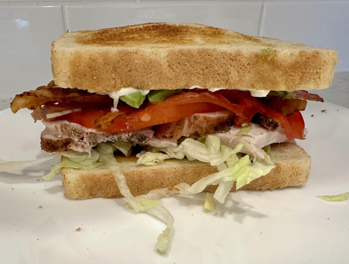 Apple Smoked Turkey Breast with shredded lettuce, heirloom tomato, avocado, bacon, horseradish, mayo