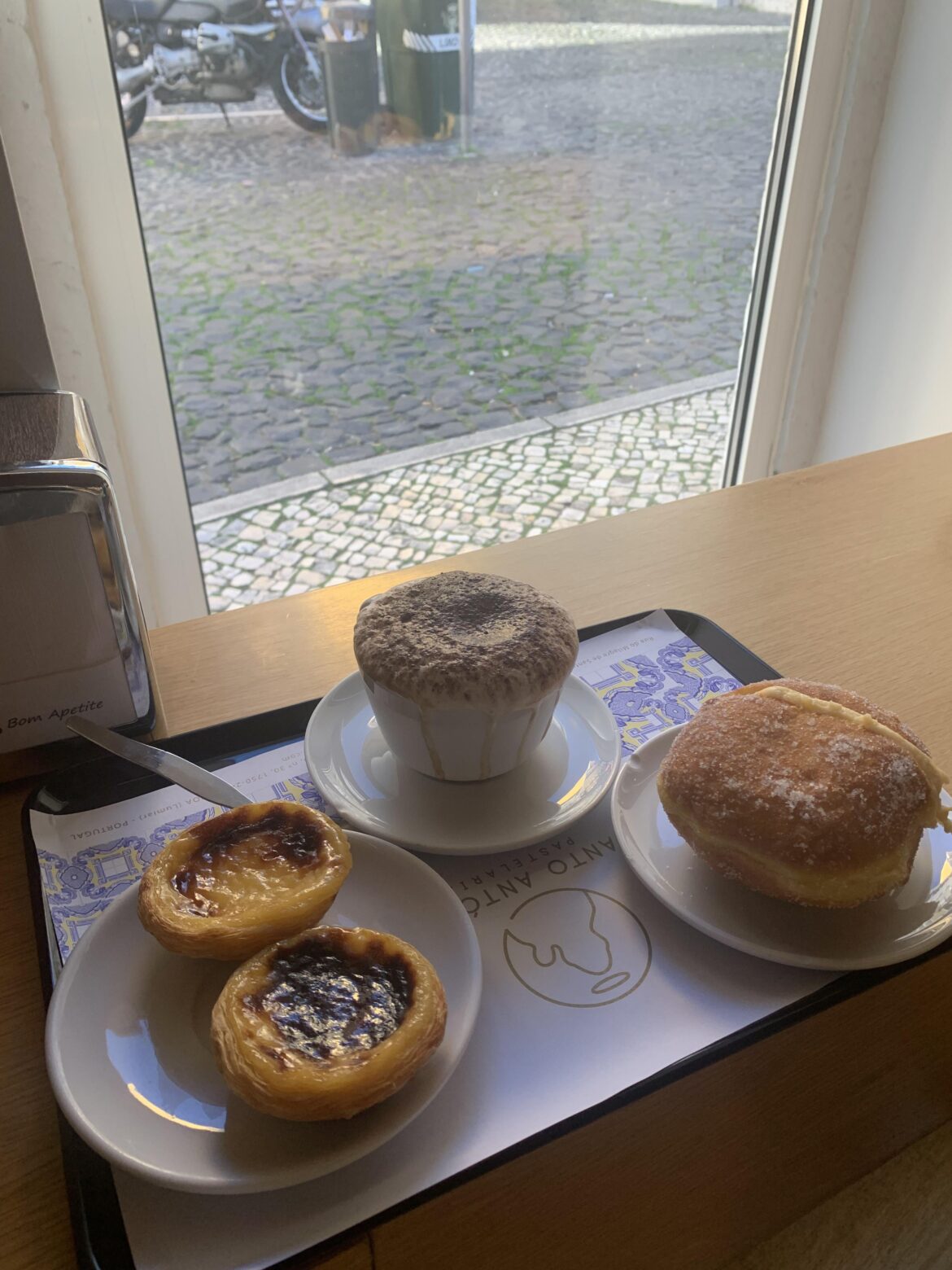 Pastel de nata and Bola de Berlin at Pasteleria Santo Antonio in Lisbon, Portugal