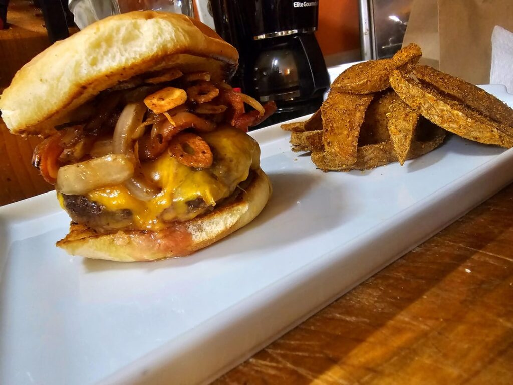 Bacon Cheeseburger w/ Grilled Onions, Fried Garlic, & Cajun Wedges