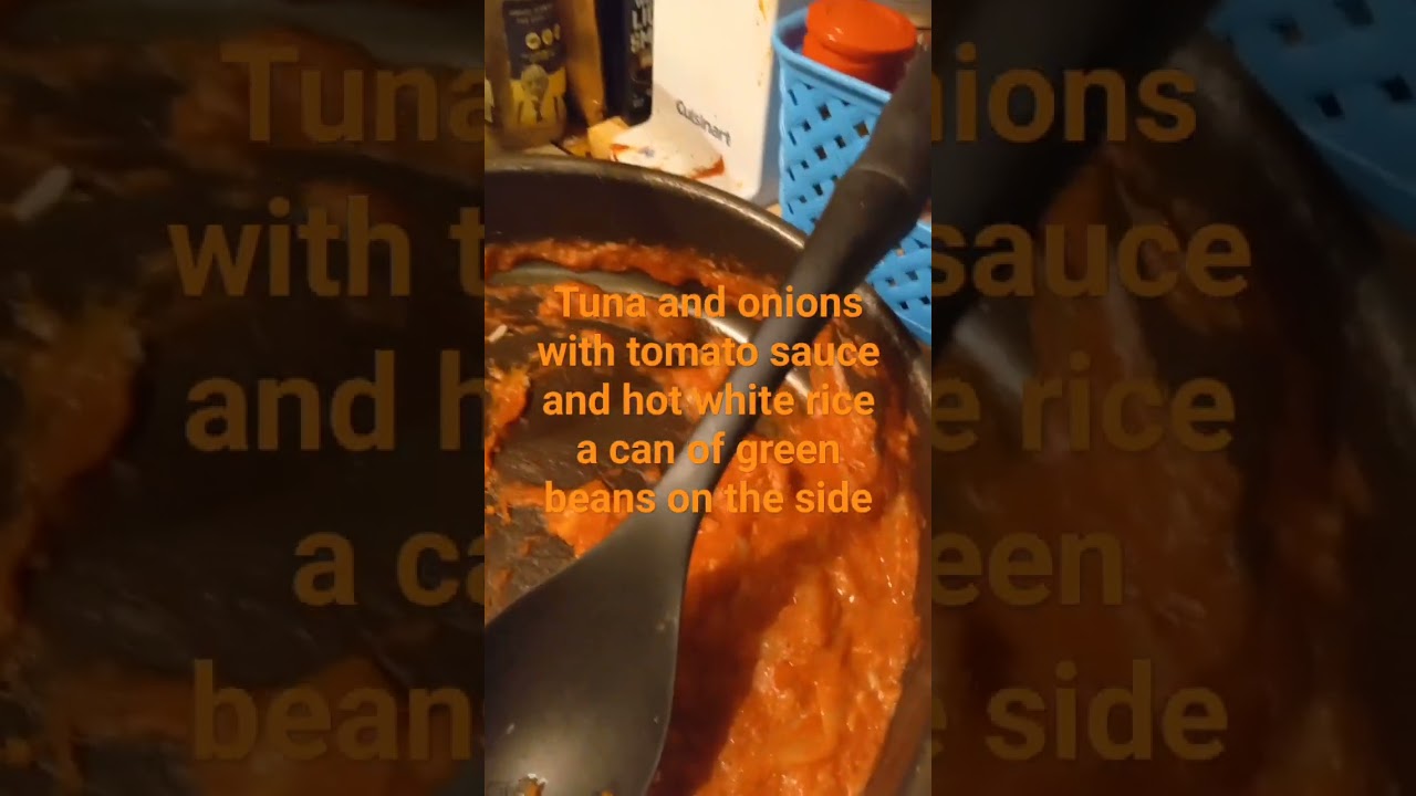 tuna and onions with tomato sauce and white rice with a can of green