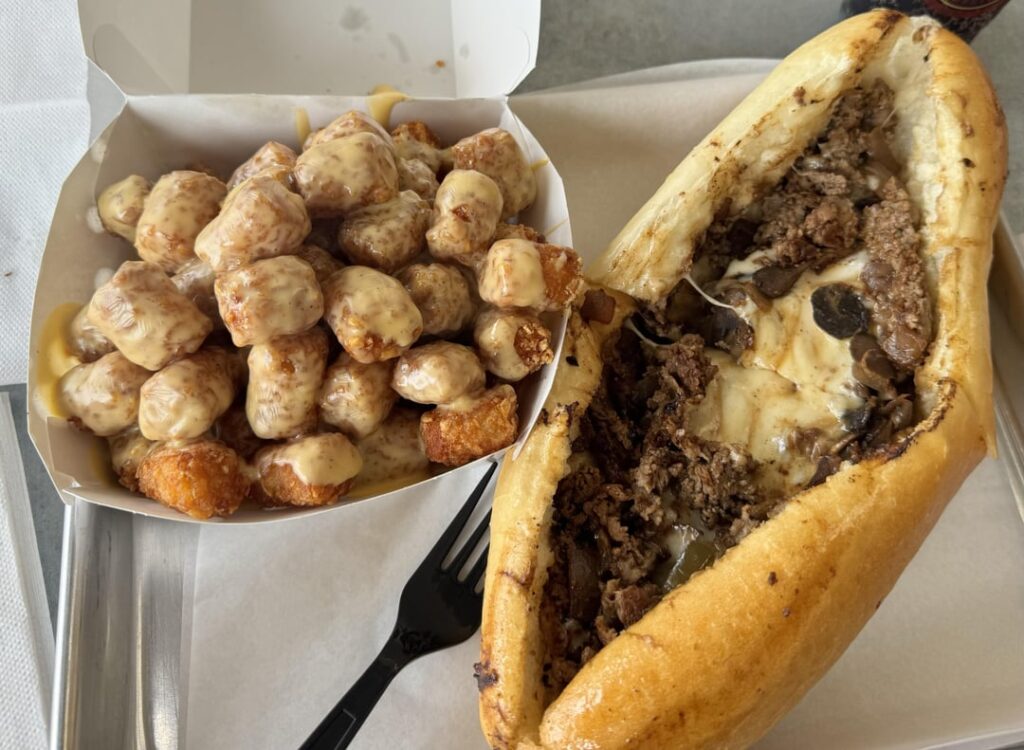 Philly Cheesesteak in Los Angeles: Sliced angus beef, grilled onions & mushrooms & melted provolone. Crispy, piping hot tots smothered in peppered cheese. Philly Cheesesteak in Los Angeles: Sliced angus beef, grilled onions & mushrooms & melted provolone. Crispy, piping hot tots smothered in peppered cheese.