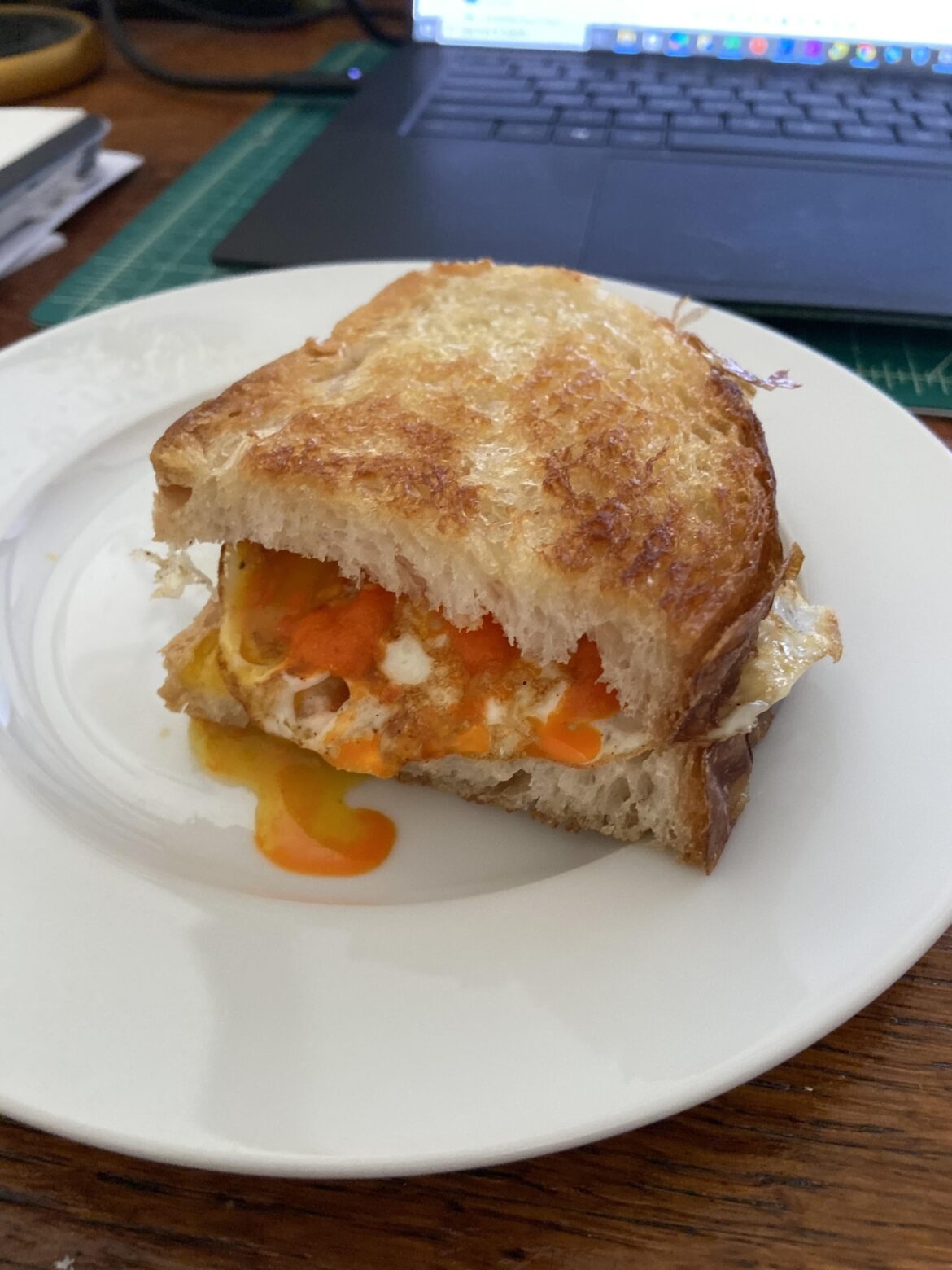 Egg and cheese sando with homemade bread and homemade fermented hot sauce.