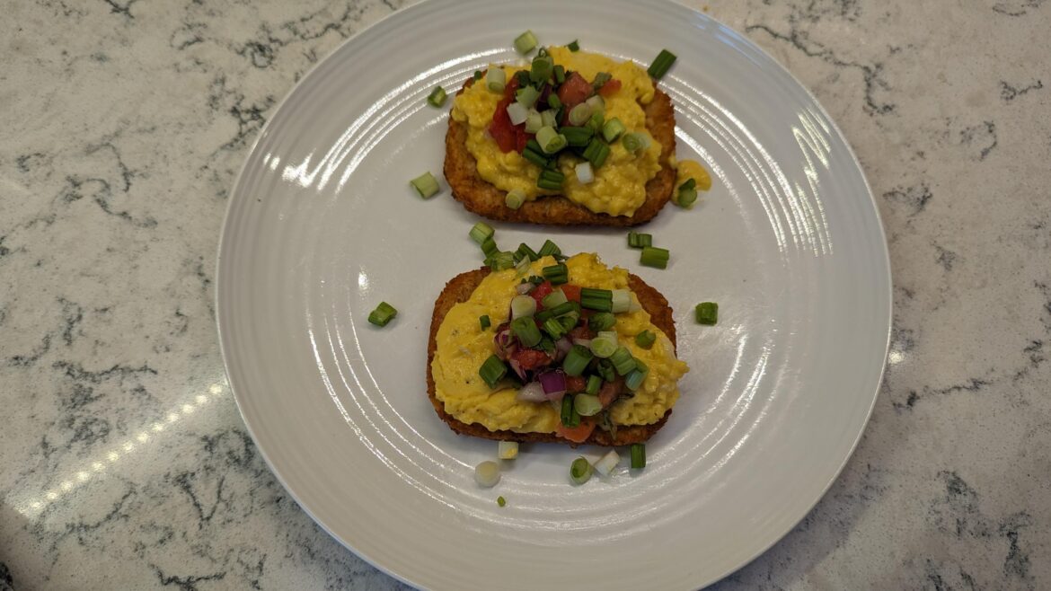 Buttery scrambled eggs over hashbrowns with Pico de Gallo and green Onions.