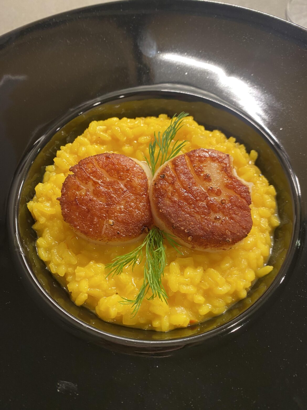 Scallops seared in duck fat and saffron risotto
