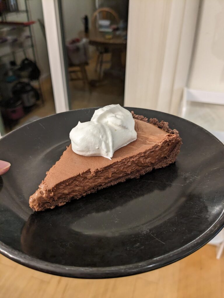 Chocolate mousse tart with chocolate shortbread crust and whipped cream