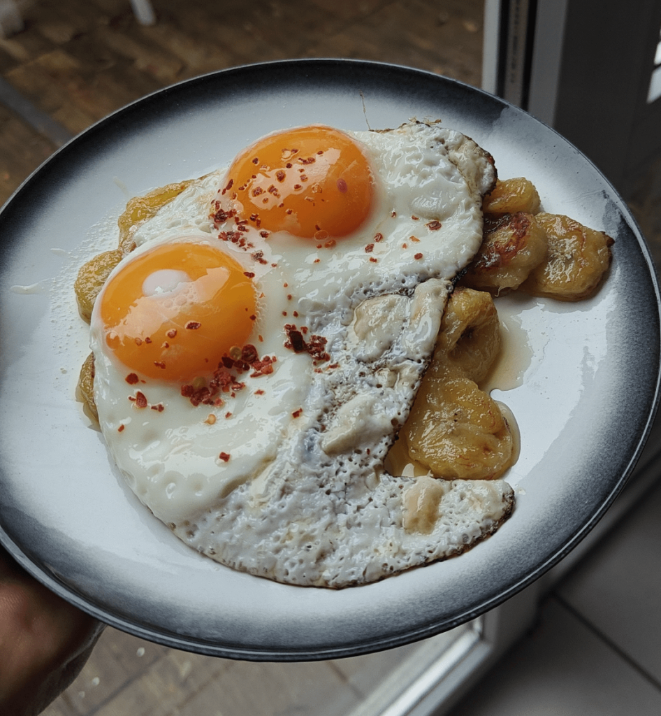 Fried banana slices with an egg on it