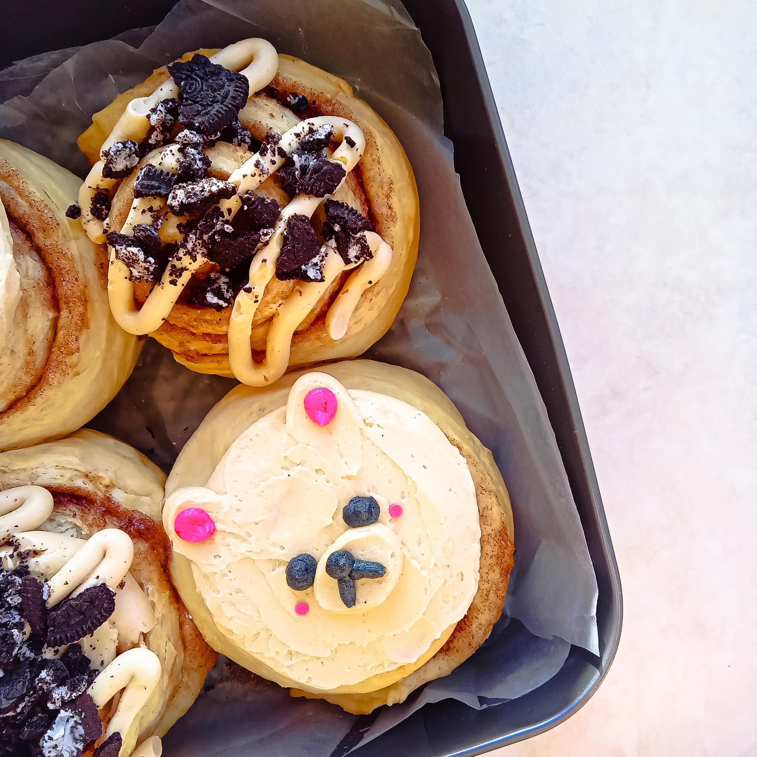 homemade cinnamon rolls topped with coffee flavoured cream cheese and