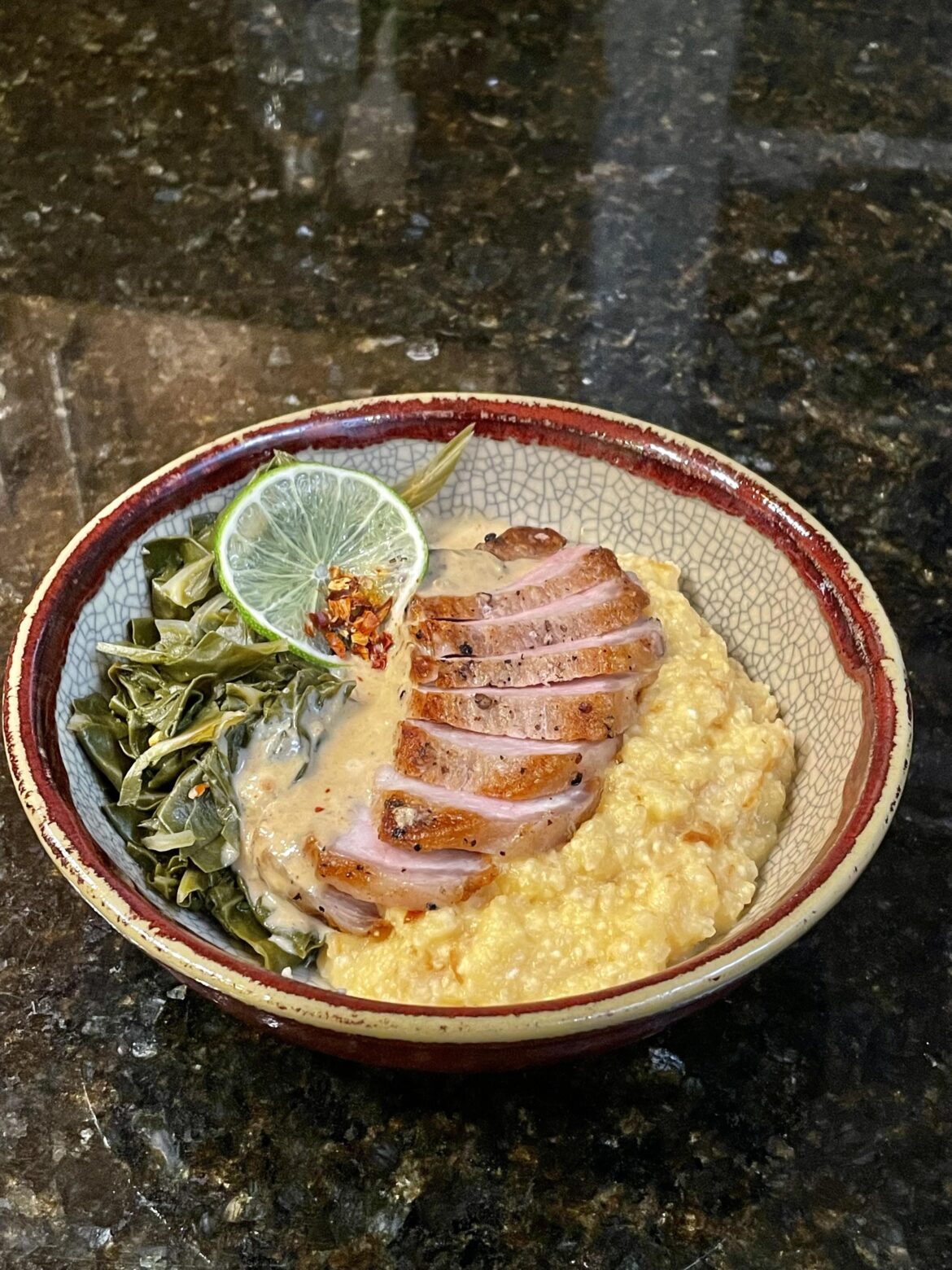 Pork Chop, Smoked Lime-Cream Soubise, Cheesy Crisped Rice, and some Collard Greens