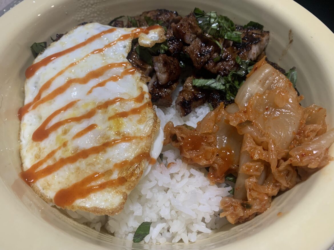 Pork, rice, kimchi with an egg on top
