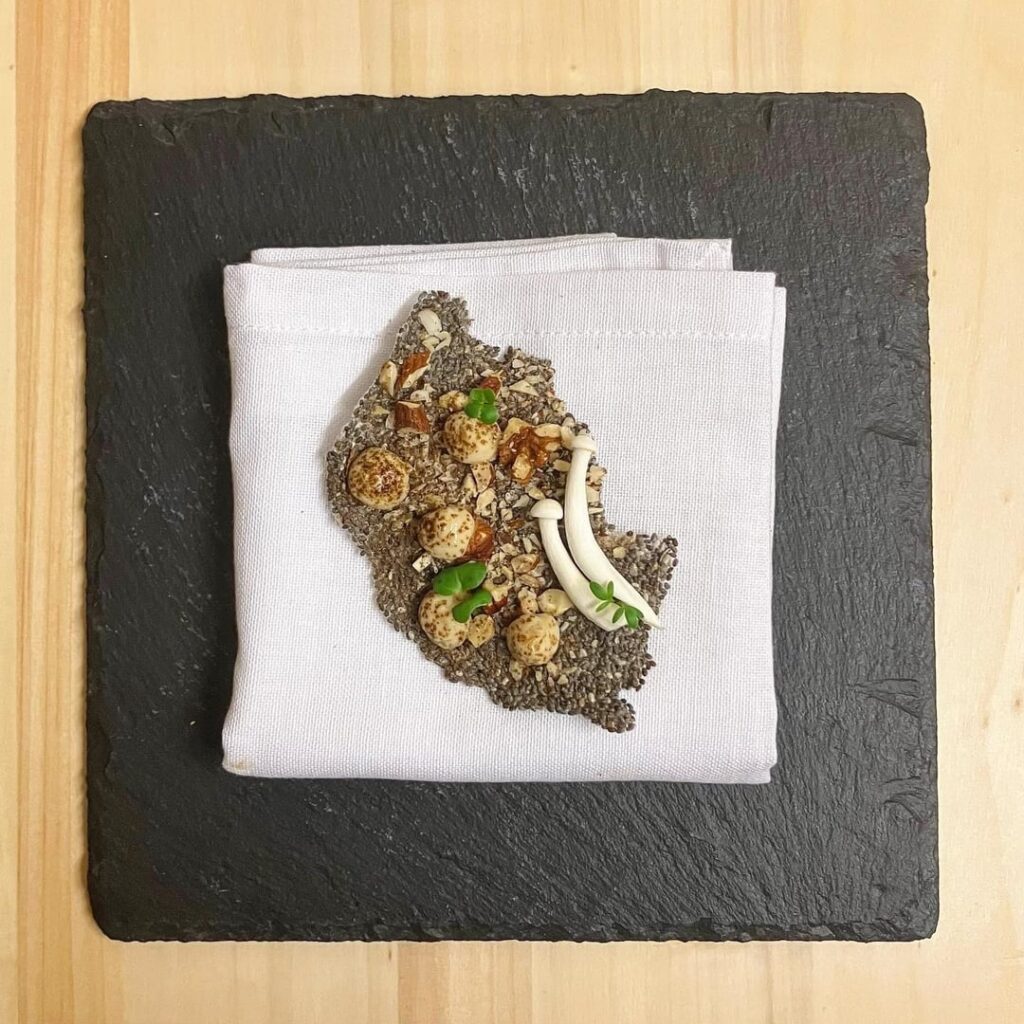 Chia seed and Mixed Nut Cracker with Shimeji Miso Purée and Porcini Powder (appetiser)