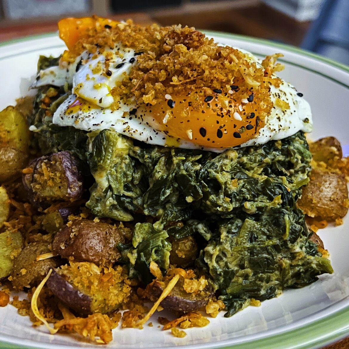 Crispy parm potatoes, creamy feta spinach, eggies and some of the panko that fell off the taters on top