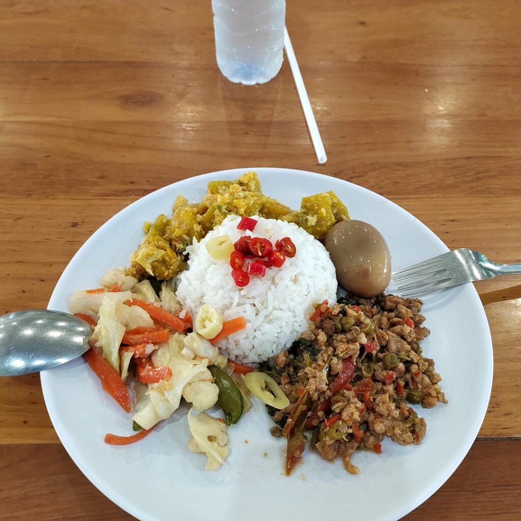 On the road to Bangkok stopped at a roadside food court at a PTT station. Pointed to four different items put it all on a plate with rice, yes it was good.