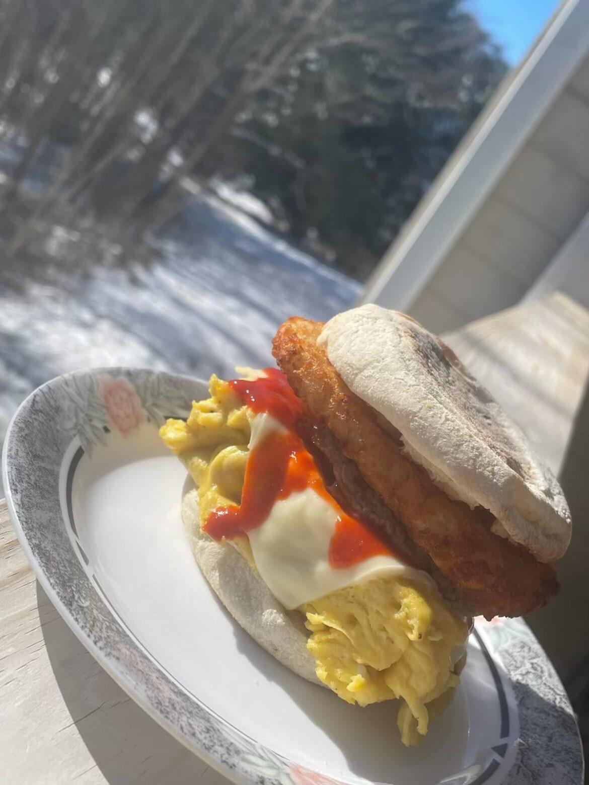 Chicken sausage, egg & cheese on sourdough English muffin w/ hash brown & blue agave sriracha