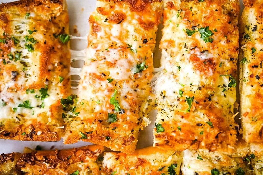 Ultimate Cheesy Garlic Bread: Crispy crust, gooey cheese, and roasted garlic goodness in every bite!