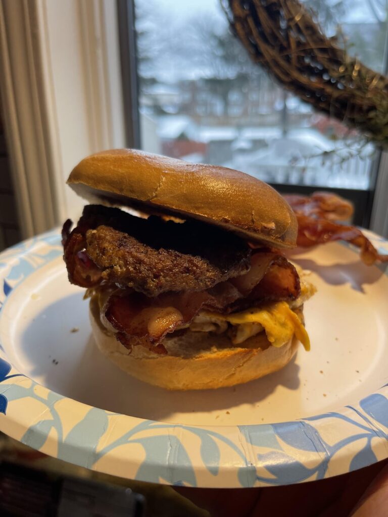 Sausage, bacon, egg, and cheese on a plain bagel.