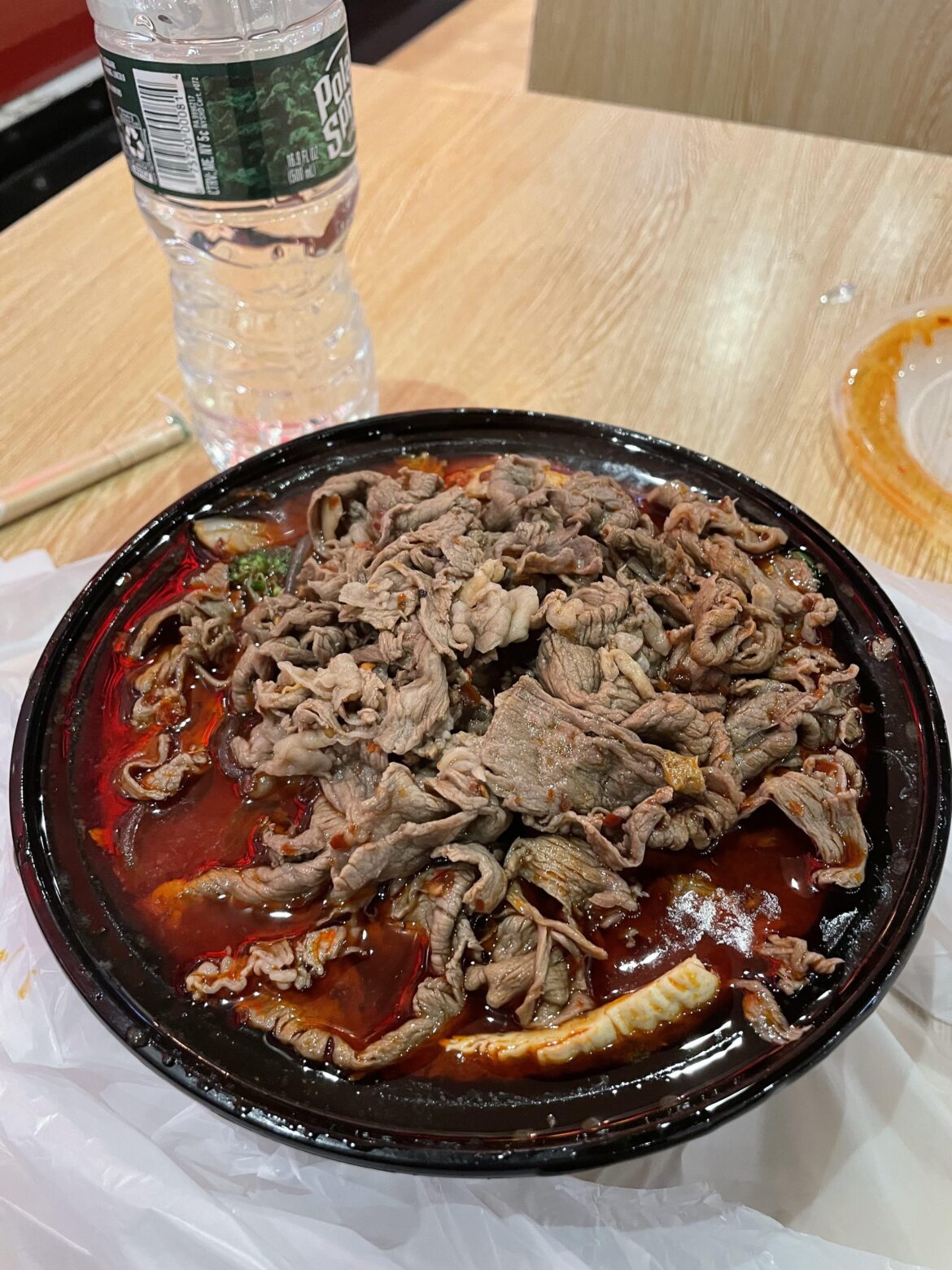 A hot pot at a food court with extra chili oil