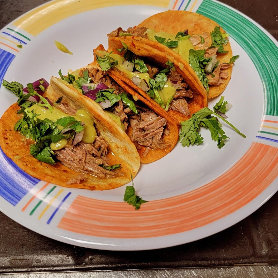 Barbacoa tacos. Guacamole salsa, and red salsa.