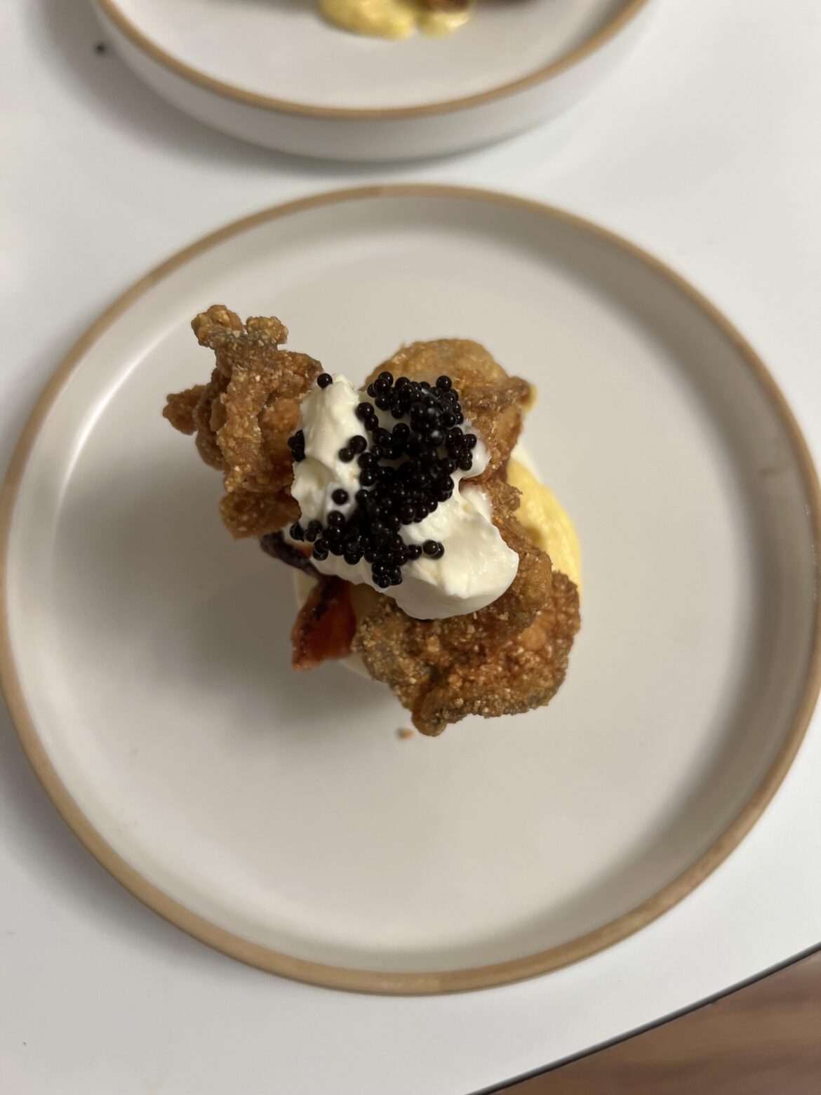 Deviled egg, crispy oyster, bacon candy, crème fraiche, caviar
