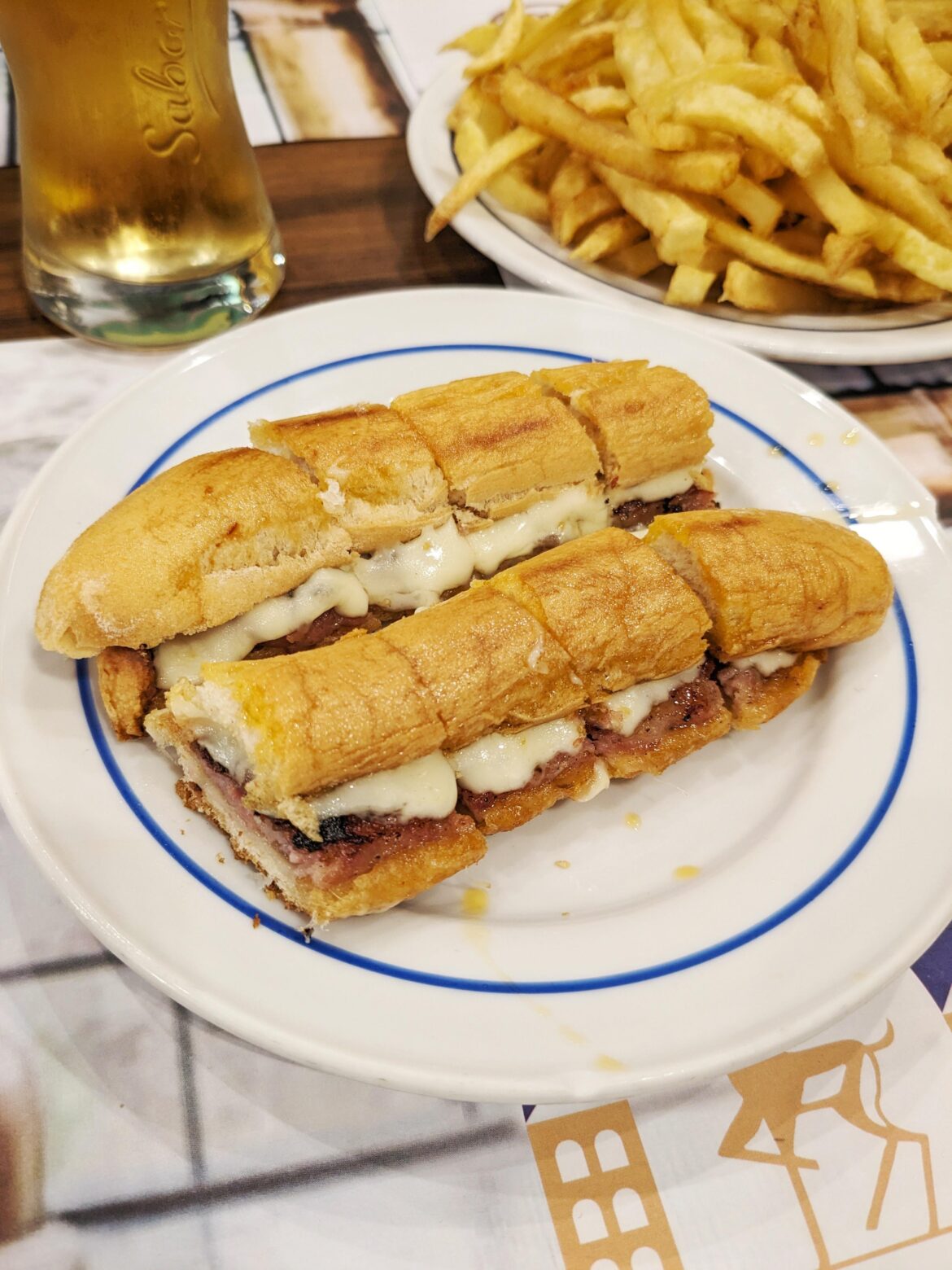 The Cachorrinho "Hot Dog Sandwich" Portuguese hot dog, cheese, butter, piri piri sauce pressed on local bread. From Cervejaria Gazela in Porto, Portugal.