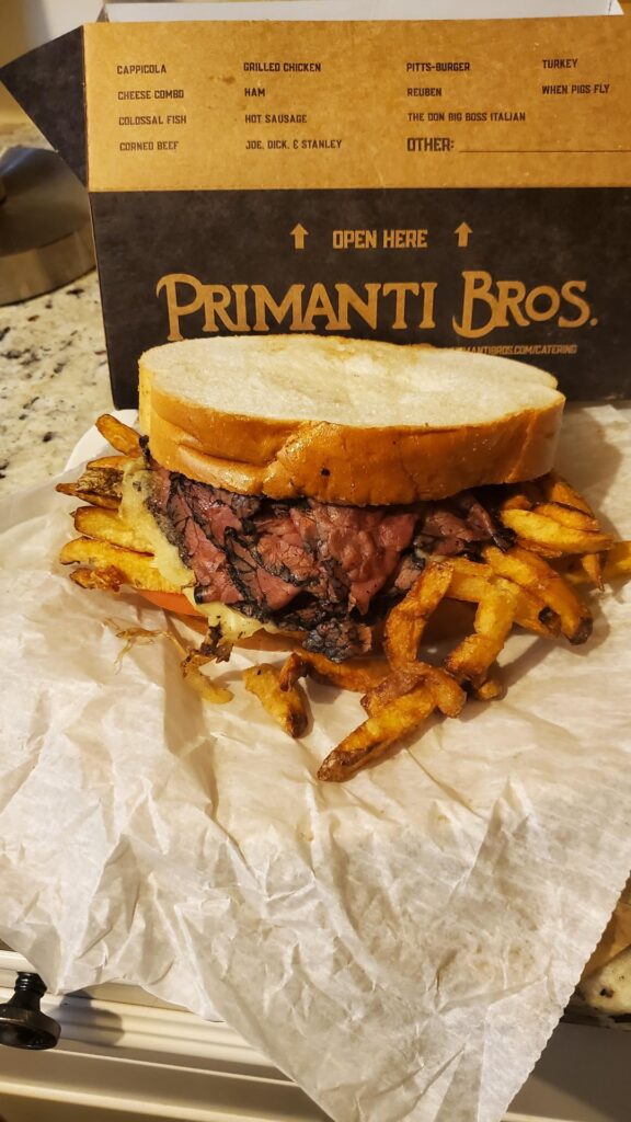 Pastrami and Swiss cheese with fries on Italian bread.