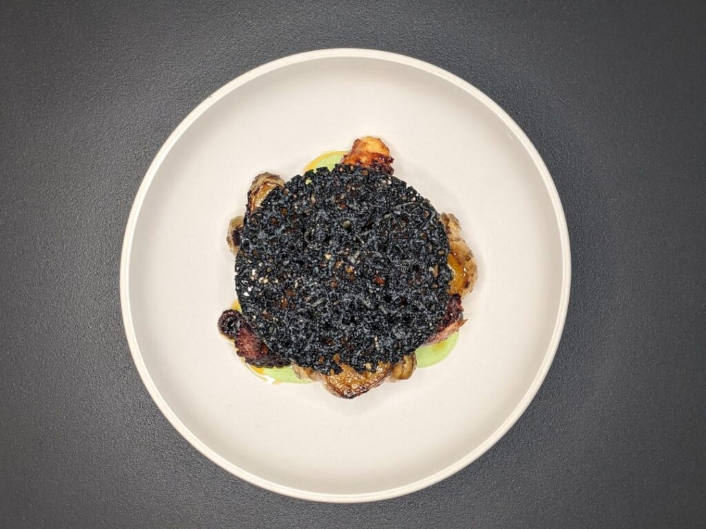 Grilled Octopus, sunchokes confit in duck fat, dill yogurt, szechuan chili oil, squid ink pecorino frico