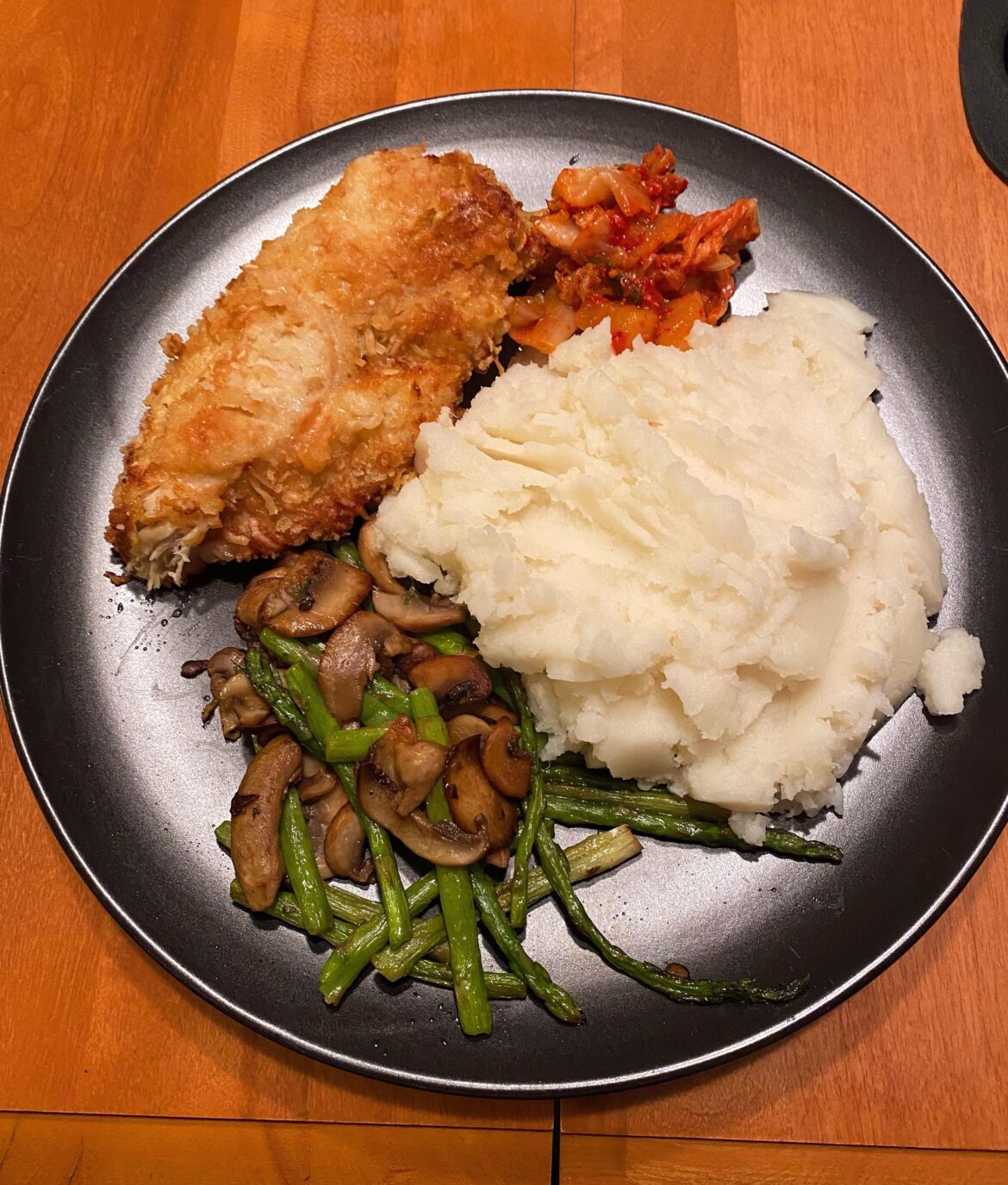 Panko breaded chicken breast, mashed potatoes, sautéed asparagus and mushrooms with a side of kimchi