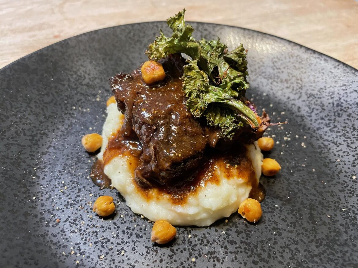 Braised lamb, mashed potatoes, crispy kale, and roasted chickpeas