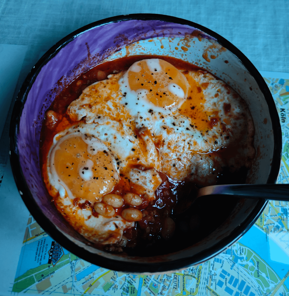 Chili con carne with 2 eggs on it