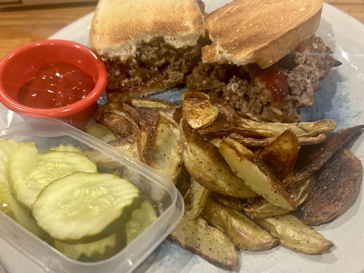 meatloaf sandwiches with horseradish and caramelized onions with potato wedges and pickles