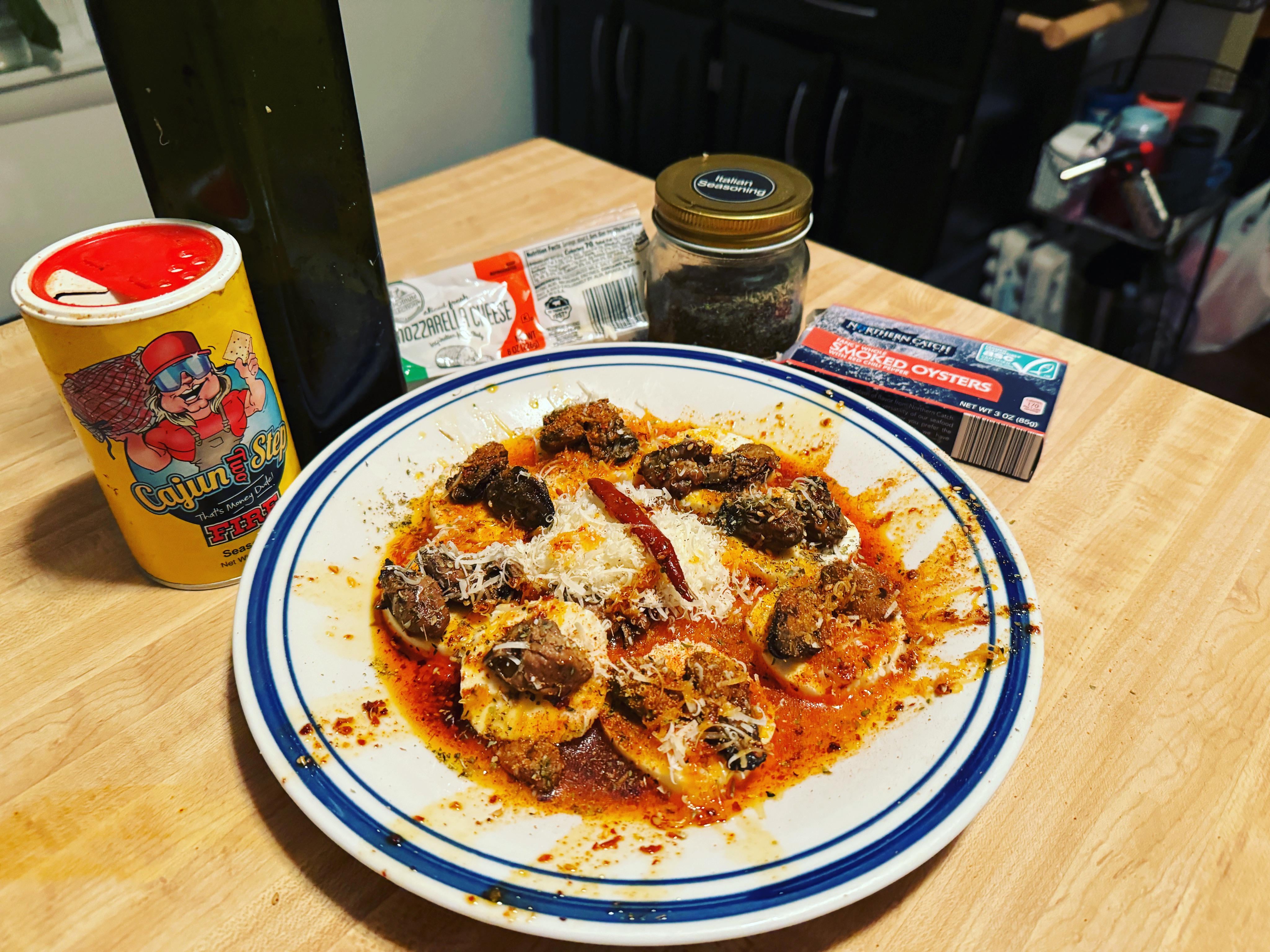 Aldi’s smoked oysters with chili pepper oil on top of mozzarella cheese