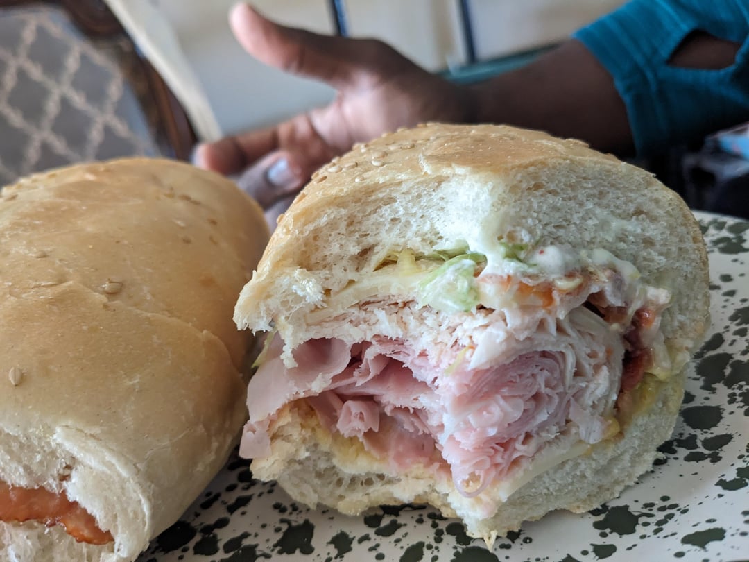 White Bread Sub with Bacon, Ham, Turkey, Lettuce, Tomato, Onion, Swiss