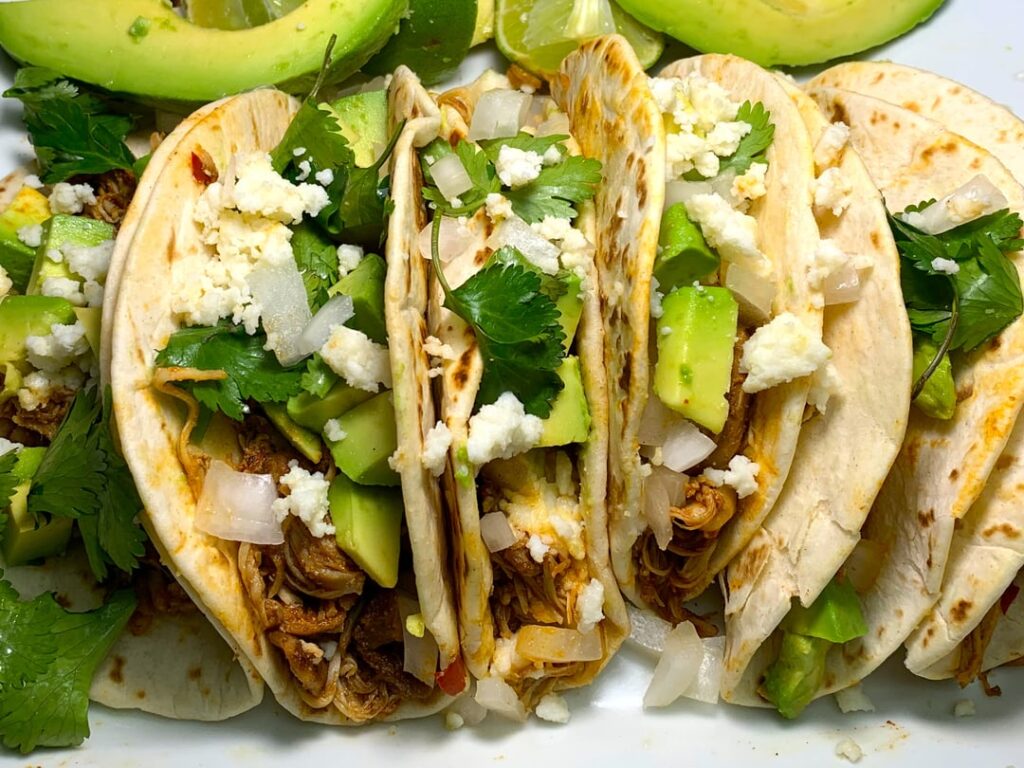 Tinga de pollo tacos in a birria spice blend
