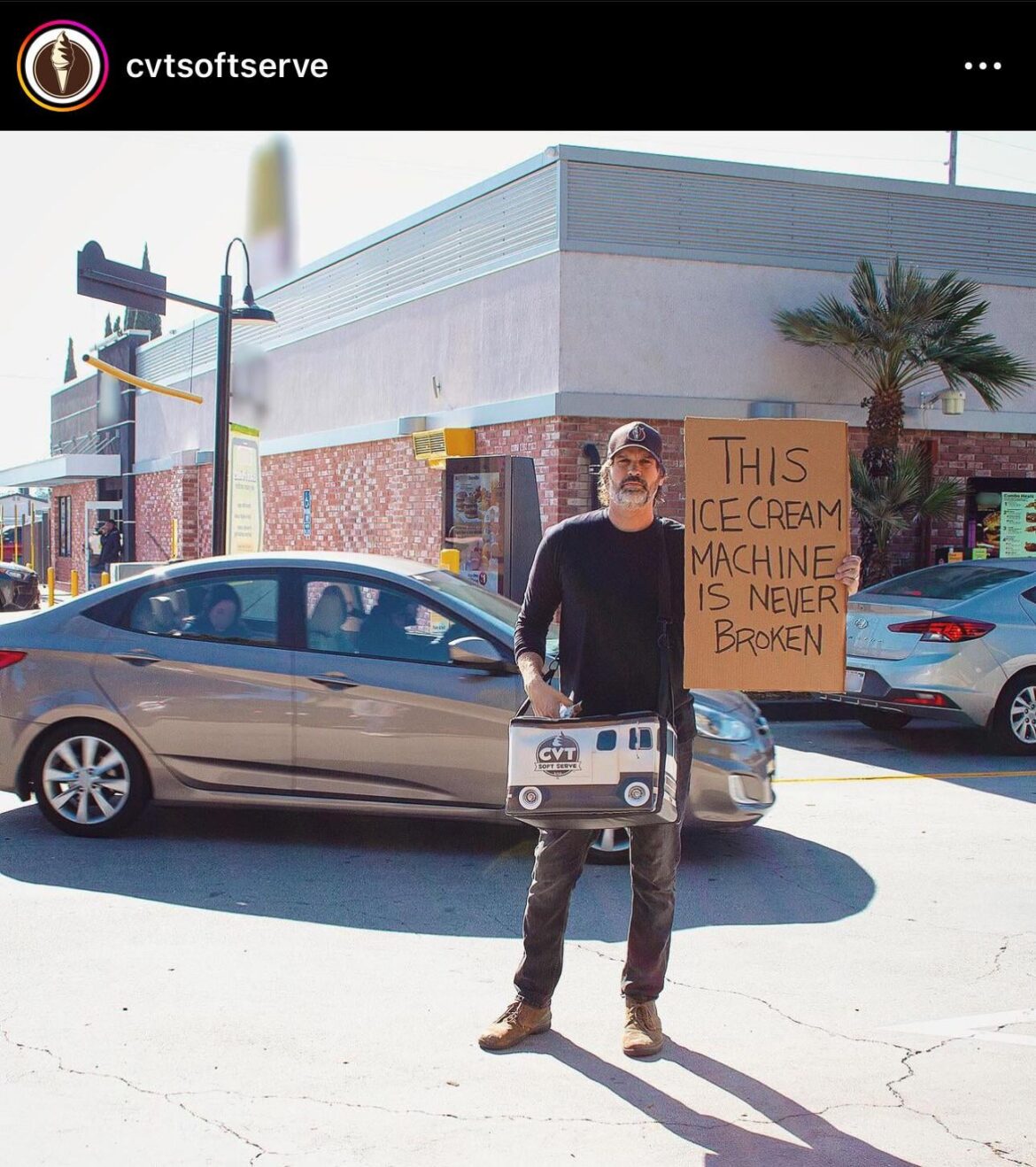 CVT Soft Serve visits a McDonalds with broken soft serve machine, gives out free ice cream while holding up “This Ice Cream Machine is Never Broken” sign.