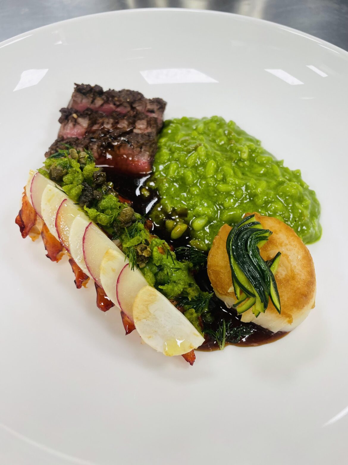 Surf and turf-fresh herb risotto-carrot reduction and Demi-glace sauce.