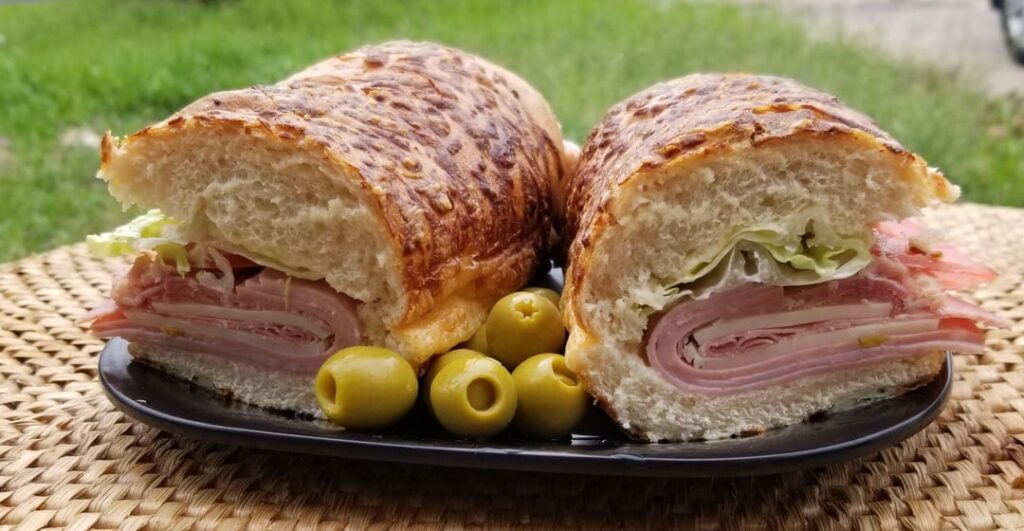 Yet another Italian: Proscuitto, panchetta, salami, ham, mortadella, smoked Auricchio provolone, LTM, champagne viniagrette - on a toasted Asiago cheese sub roll with anchovy-stuffed olives.