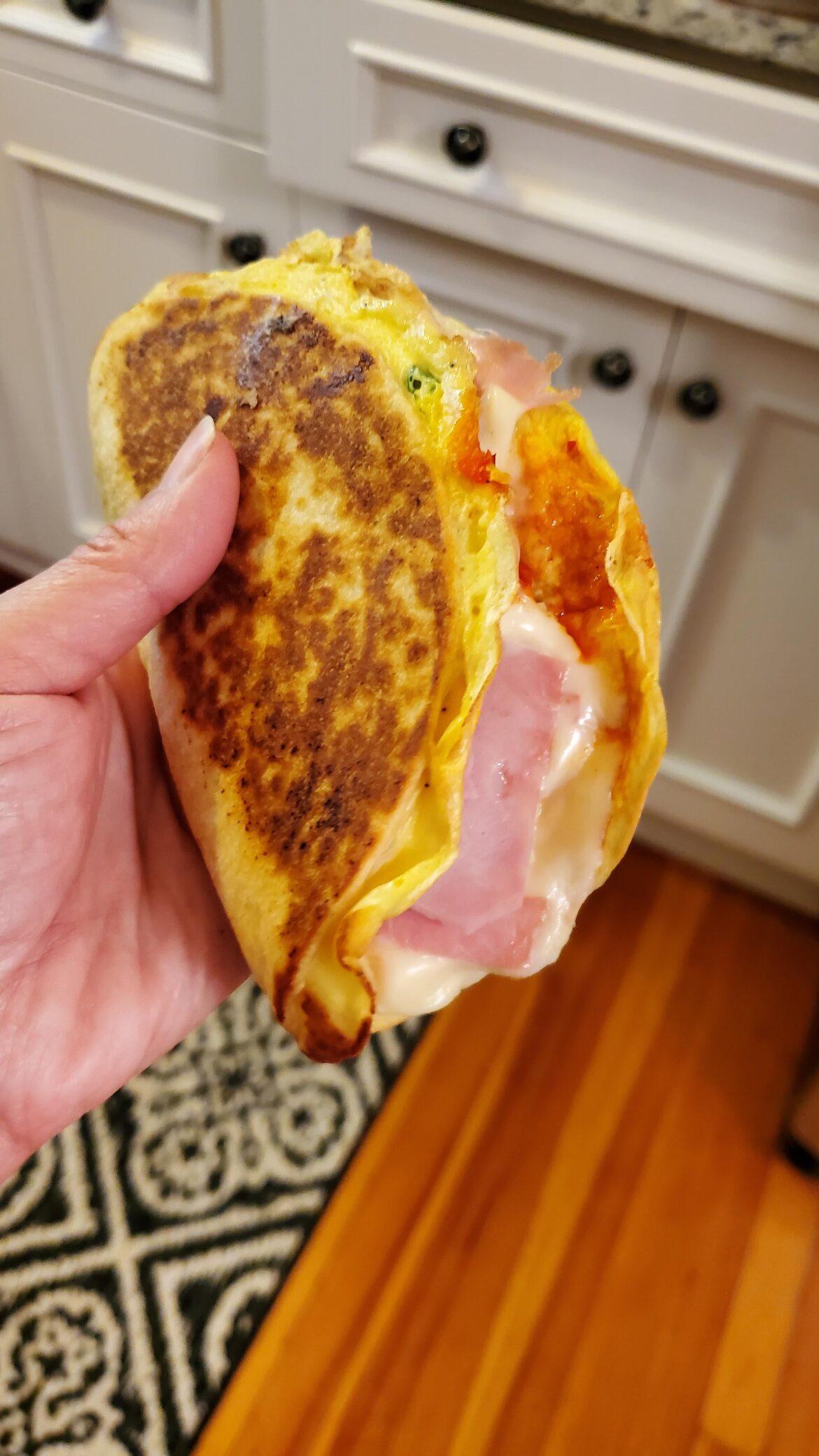 Egg omelette tortilla wrap with smoked ham and aged provolone.