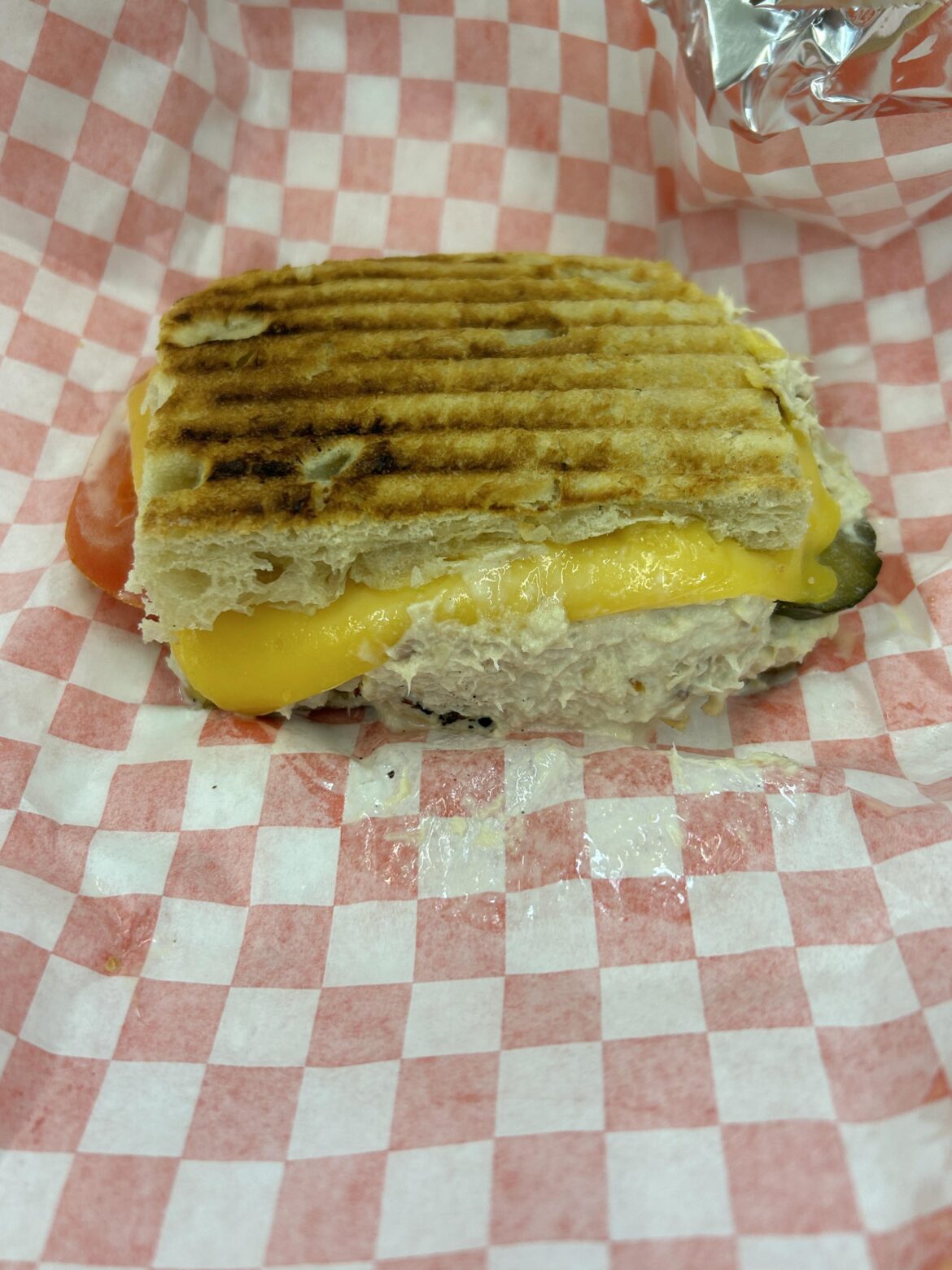 Tuna panini with cheese sweet pickles and tomatoes
