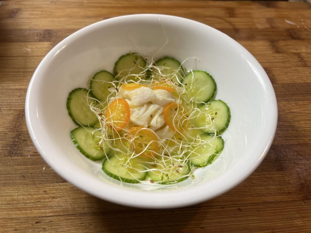 Halibut in Leche de Tigre, Poached Kumquats, Cucumber, and Radish Sprouts