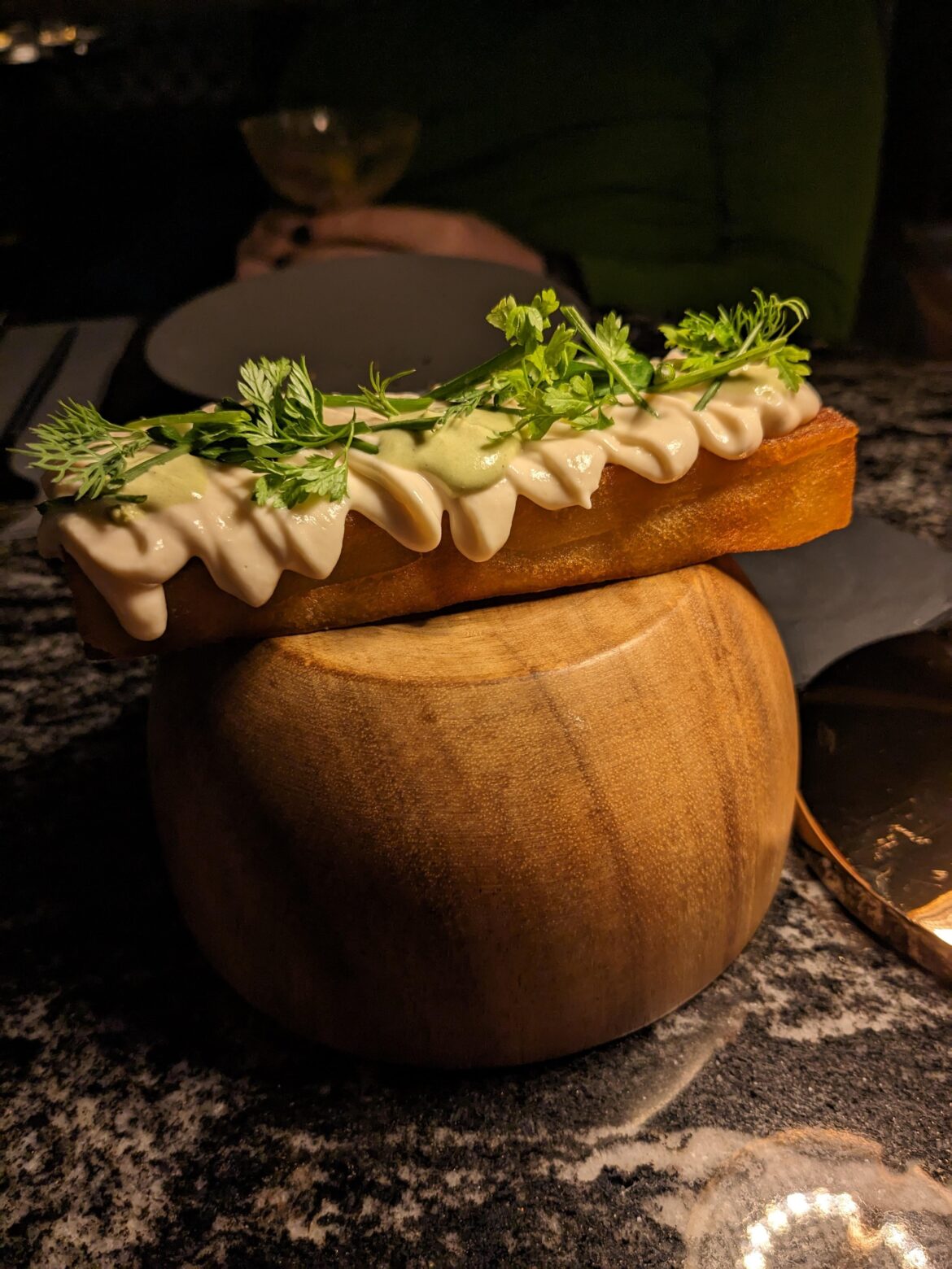 Salmon mousse on a potato pavé on an upside down bowl