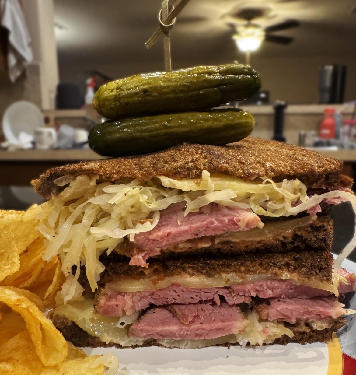 My birthday “Reuben” sandwich. Pastrami, sauerkraut, Russian dressing, and Swiss cheese on Pumpernickel, topped with pickles. Everything homemade except the bread, cheese, & chips.