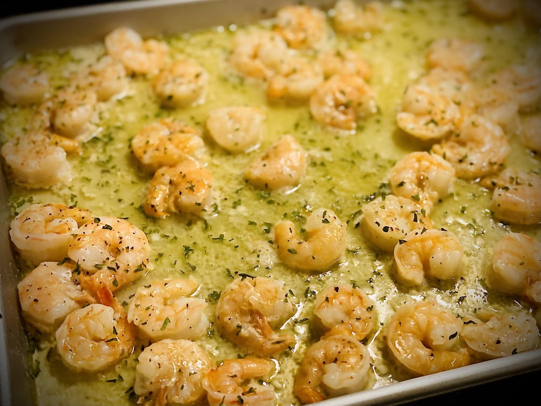 Homemade garlic butter shrimp over bow tie pasta with a side of